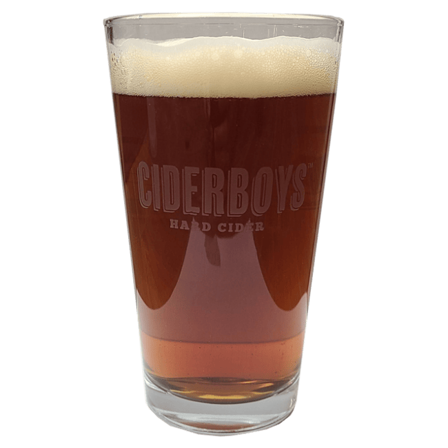 Pint glass filled with dark-colored beer and featuring the Ciderboys logo etched into the glass.