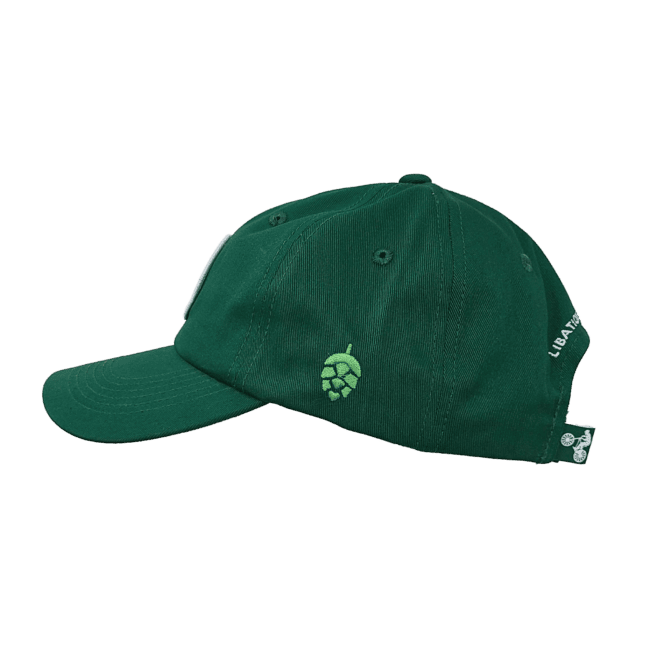 Side view of a dark green baseball cap. The baseball cap features a light green hop embroidered on the side and a green flag tag on the back with a bicyclist on it.