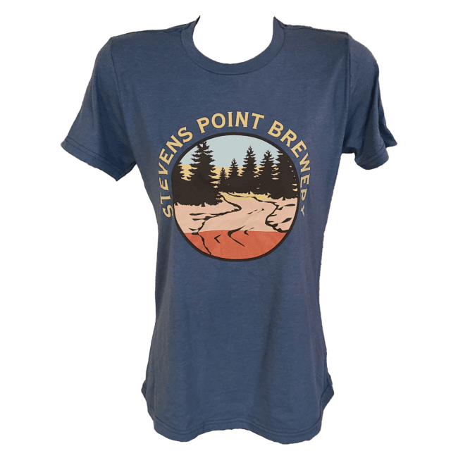 Front view of a dark blue ladies fit t-shirt with a circular logo printed on the chest. Around the circle, the words "Stevens Point Brewery," are printed in yellow. Inside of the circle, a scene of pine trees with a river are seen in dark brown with stripes of color showing through in the background. The stripe colors are light blue, yellow, peach, and orange.